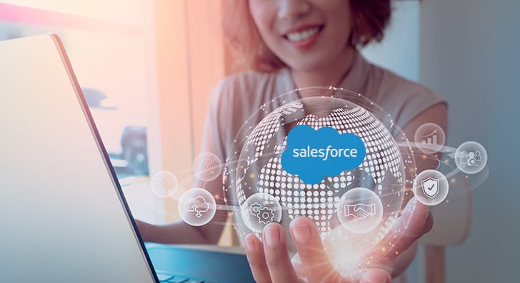 A Woman With A Laptop Holding What Looks Like A Sphere Of Salesforce